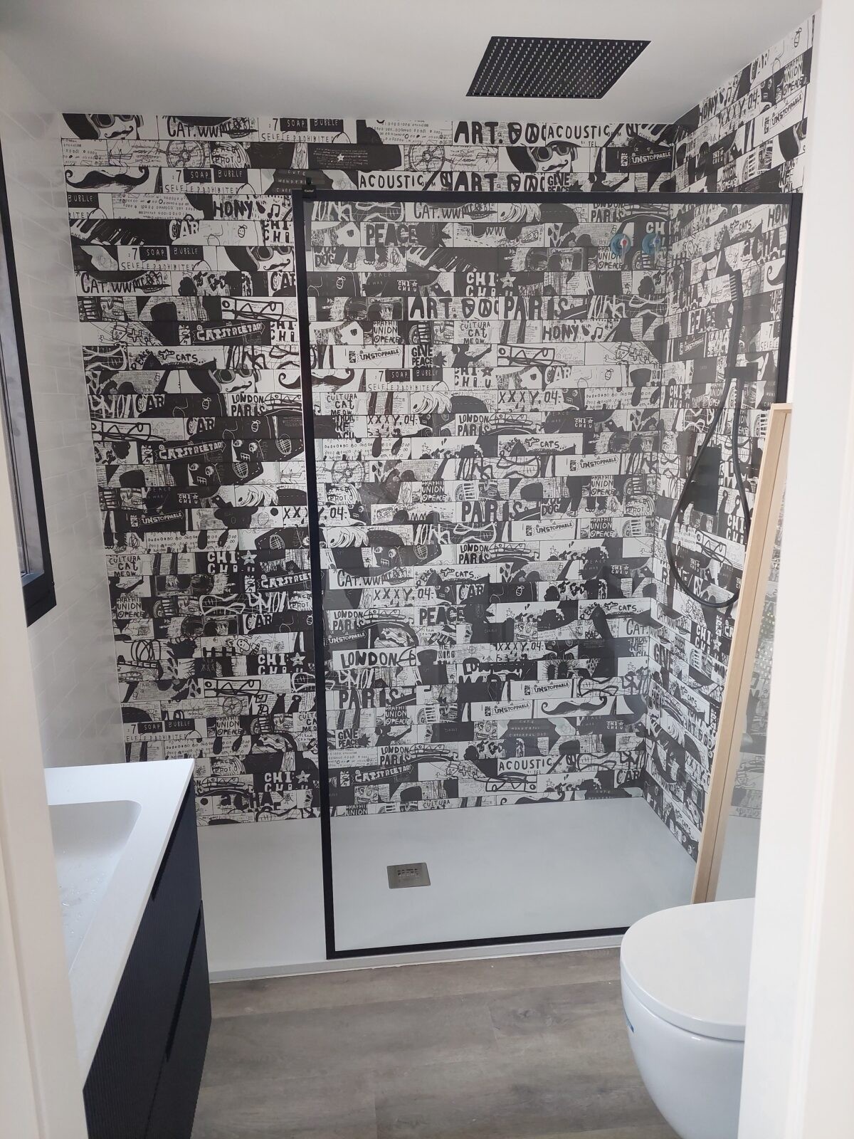 Lavabo con ducha y cerámica tipo mosaico moderno en vivienda de Cabrils